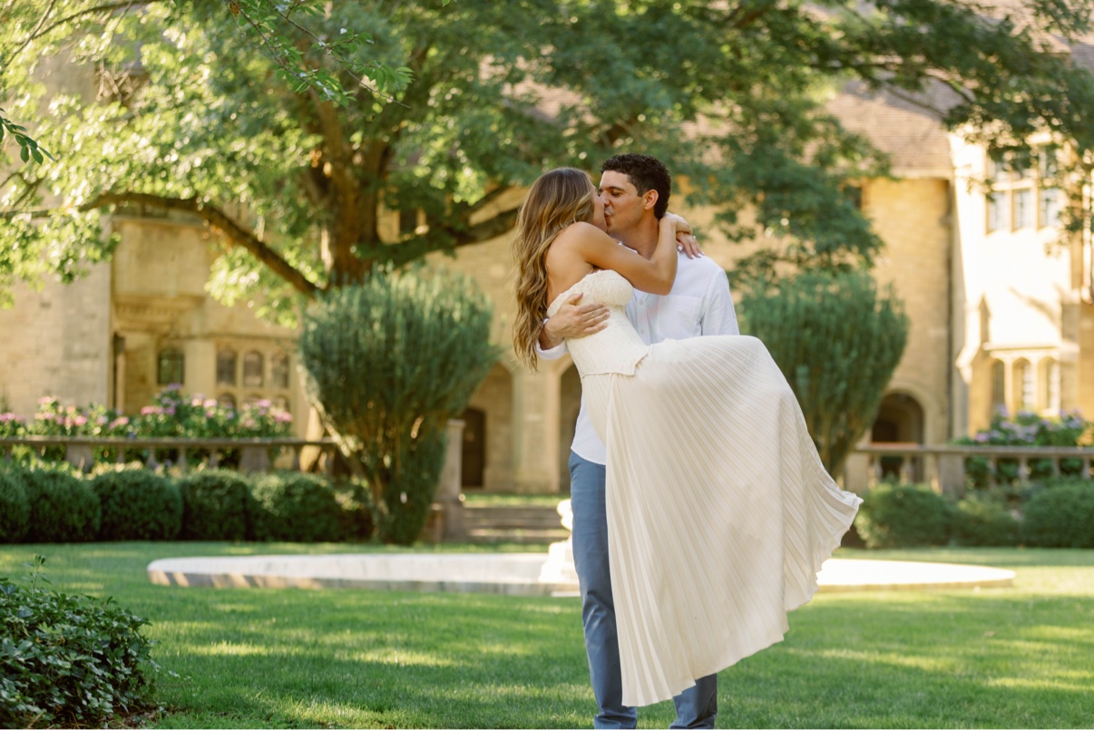 Groom-to-be lifting his fiancée on the lawn of a Long Island estate after the proposal