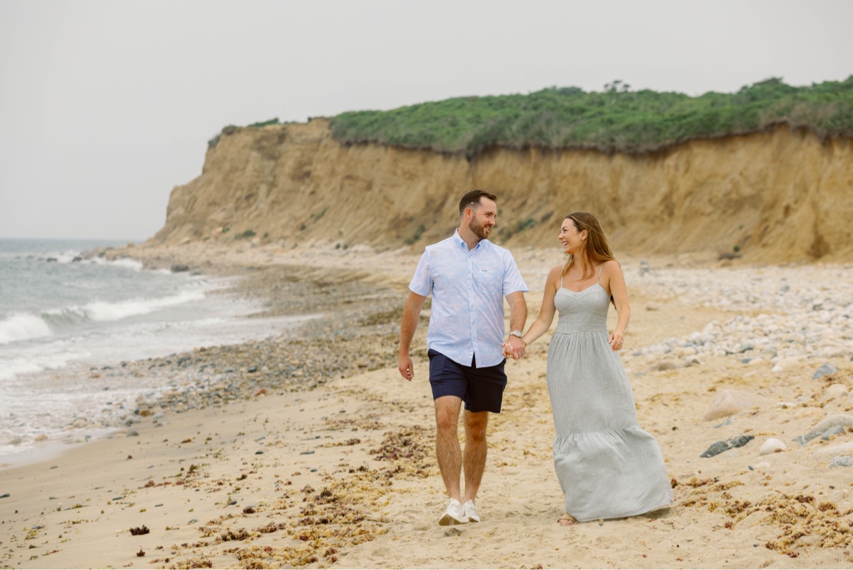 Couple walking along a Long Island beach beneath the clay bluffs