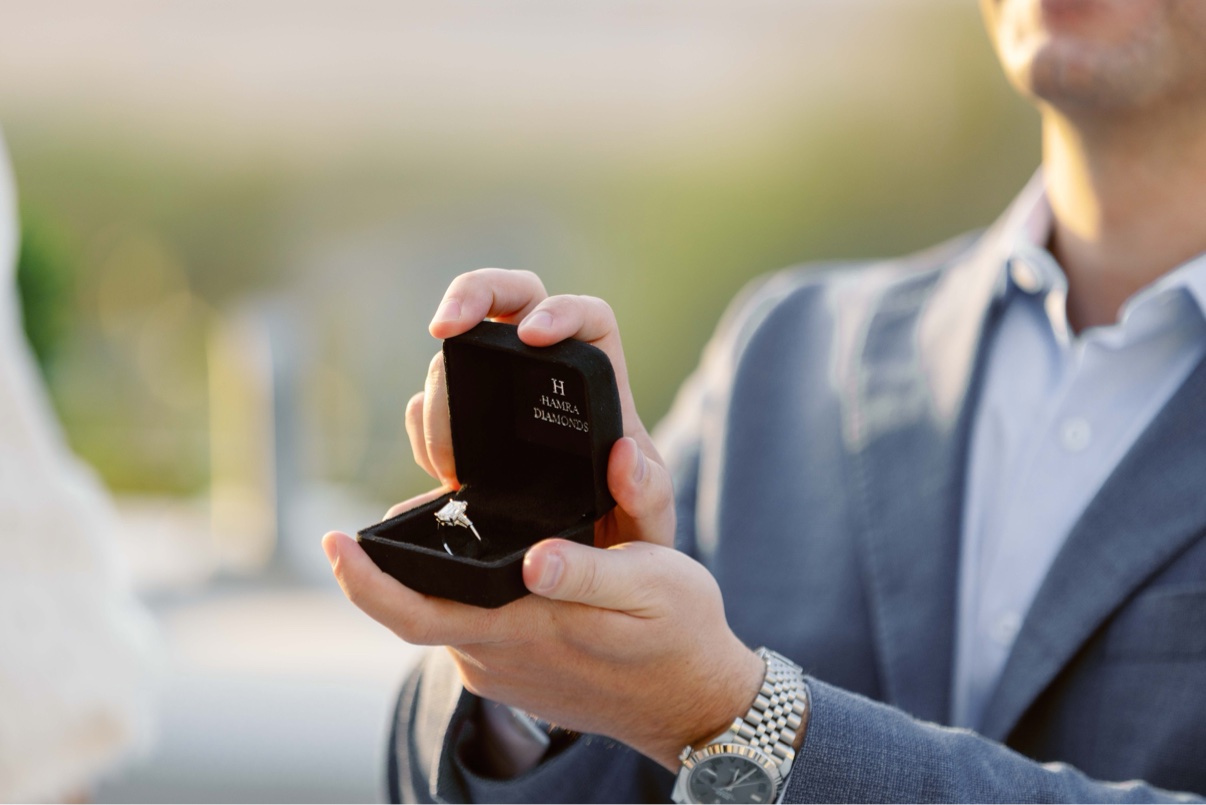 The engagement ring in its box, held moments before a surprise proposal on Long Island
