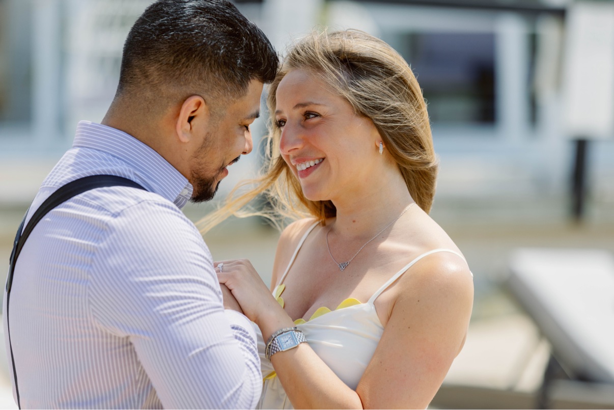 Close-up of a couple smiling at each other just after a surprise proposal on Long Island