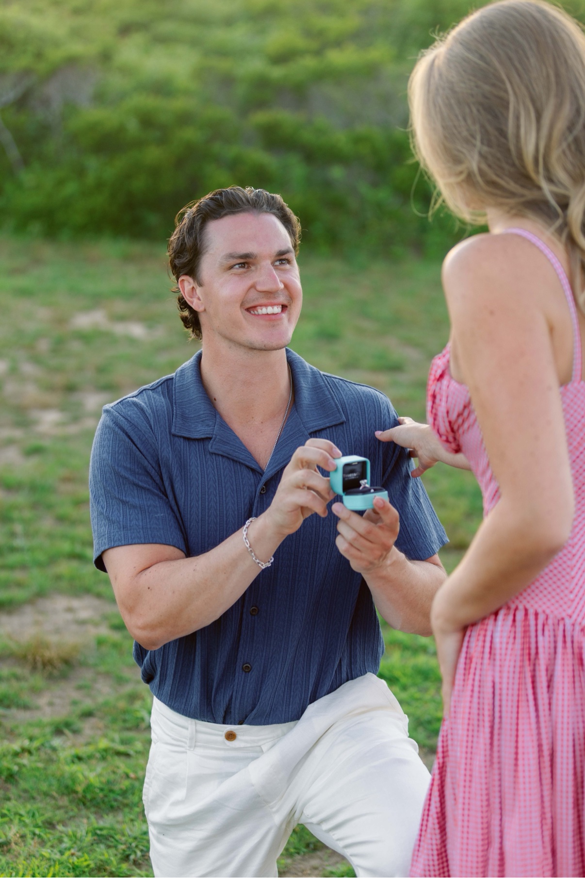 On one knee with the ring box open — a surprise proposal on Long Island