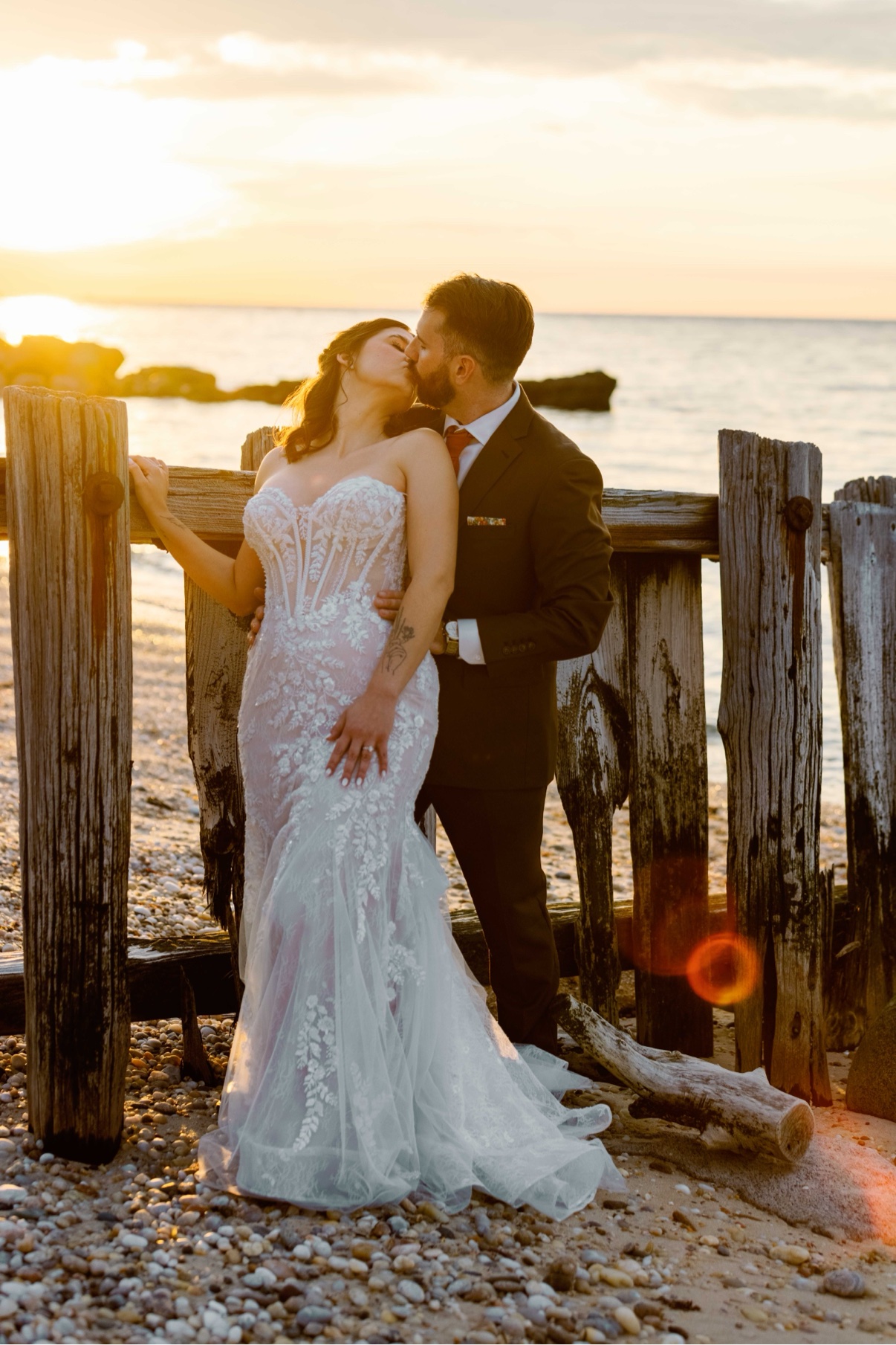 Newlyweds on the sand at golden hour